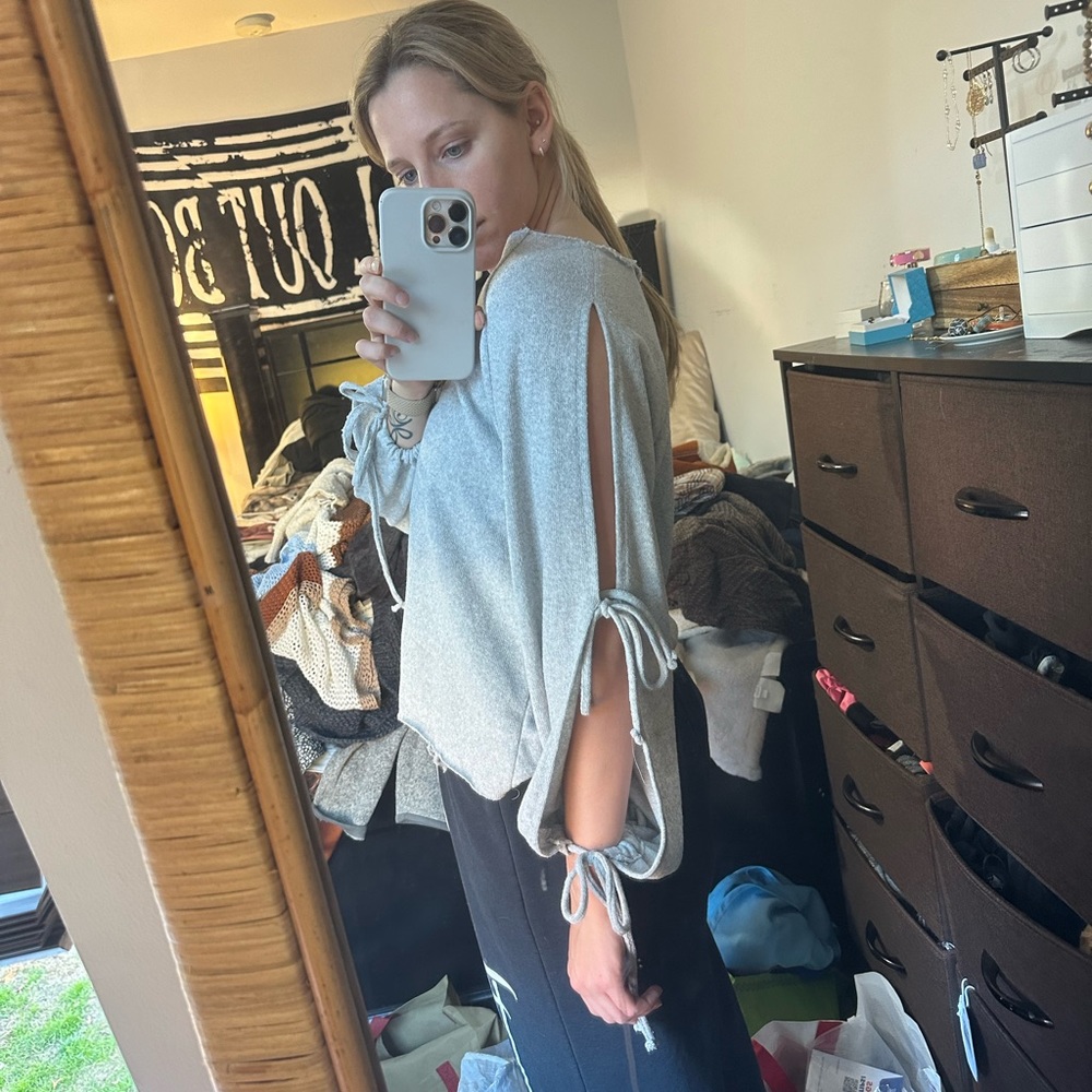 Pull & bear V neck sweater. Sleeves are cut out with ties. Worn a few times